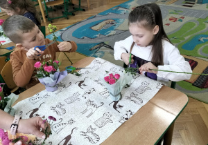 Arina i Antek odcinają kwiaty do bukietu