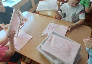 Delikatne zdejmowanie kartek z sit przez dzieci.